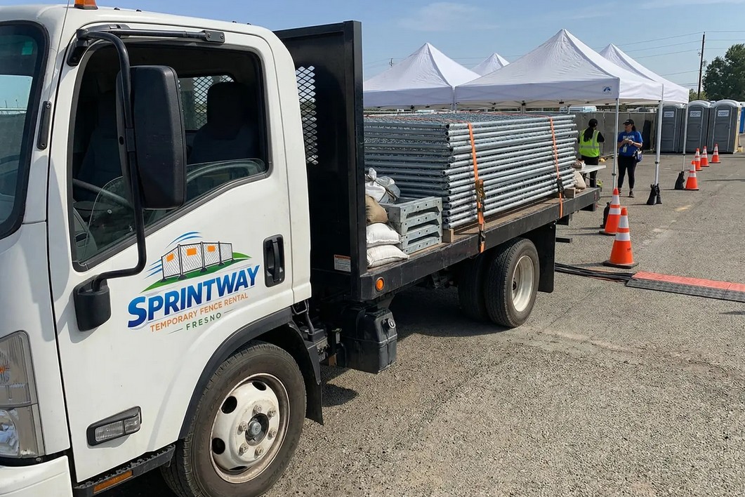 Sprintway Temporary Fence Rental Fresno delivery truck loaded with temporary fence panels arriving at a job site